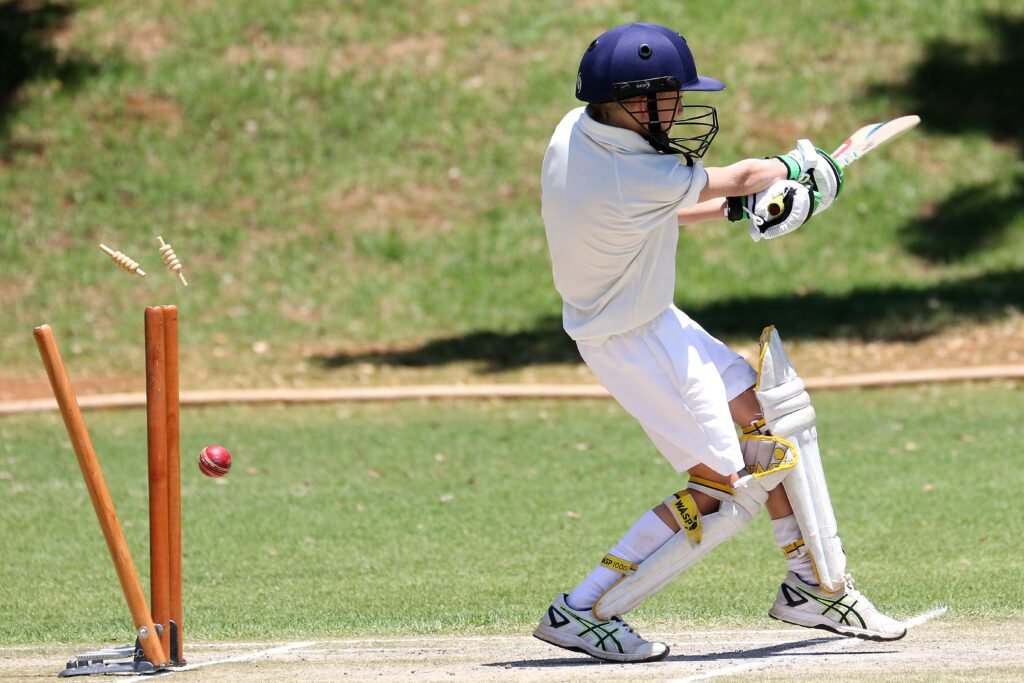 India vs West Indies ODI 2026: Auqib Nabi’s Fiery Bowling Powers India to Series Win Young cricket player in full gear performing a sweep shot on a sunny day outdoors.